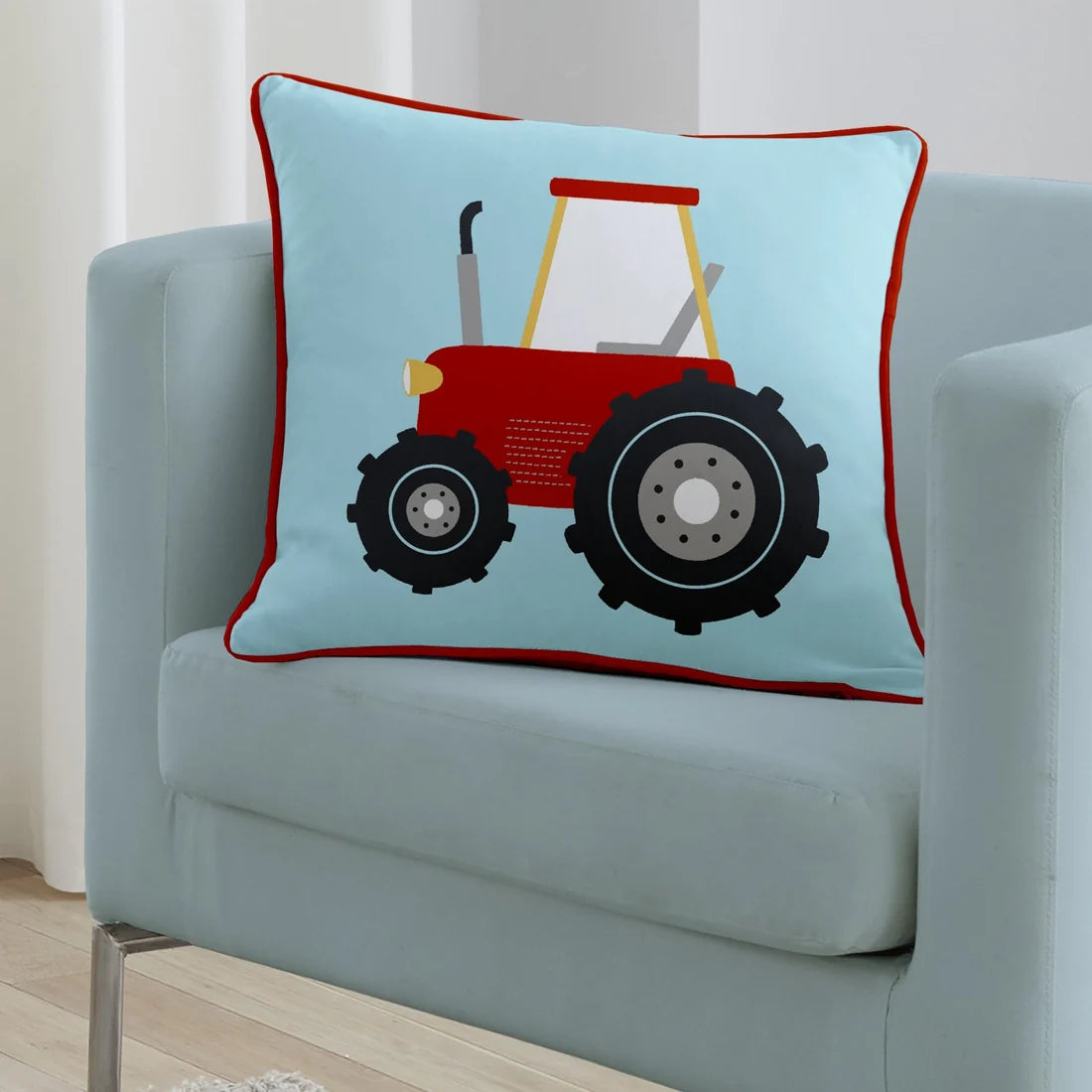 Bedlam Farmyard Friends velvet cushion in blue featuring a red tractor.