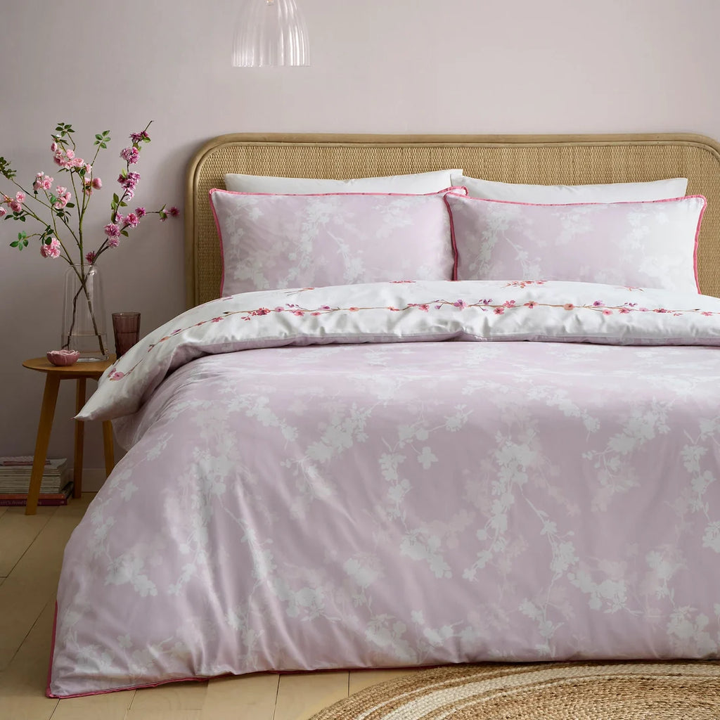 Delicate all-over blossom reverse of the Appletree Blossom Flower duvet cover set in Berry.