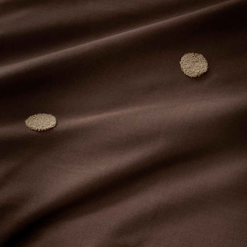 Close-up of the textured tufted finish on the Appletree Dot Garden duvet cover set.