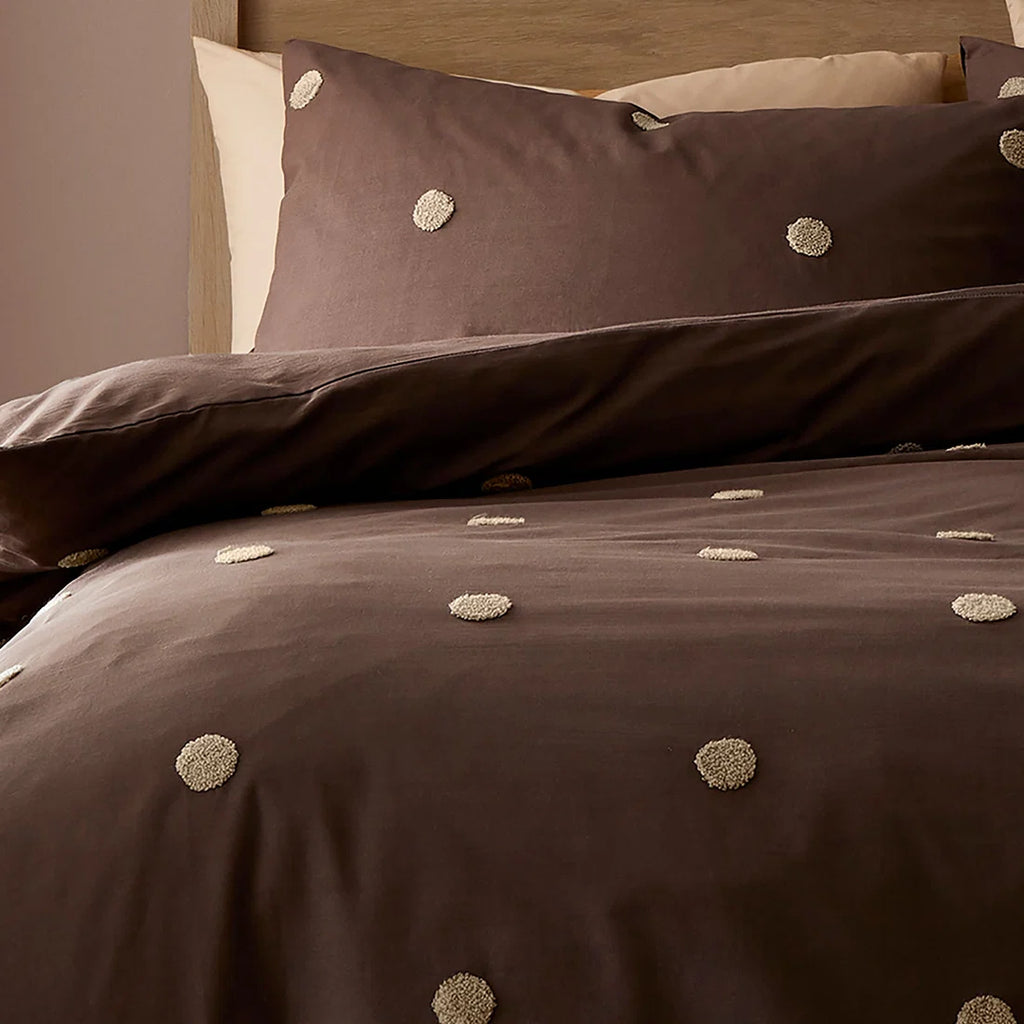 Close-up of the tufted polka dot detailing on the Appletree Dot Garden duvet cover set.