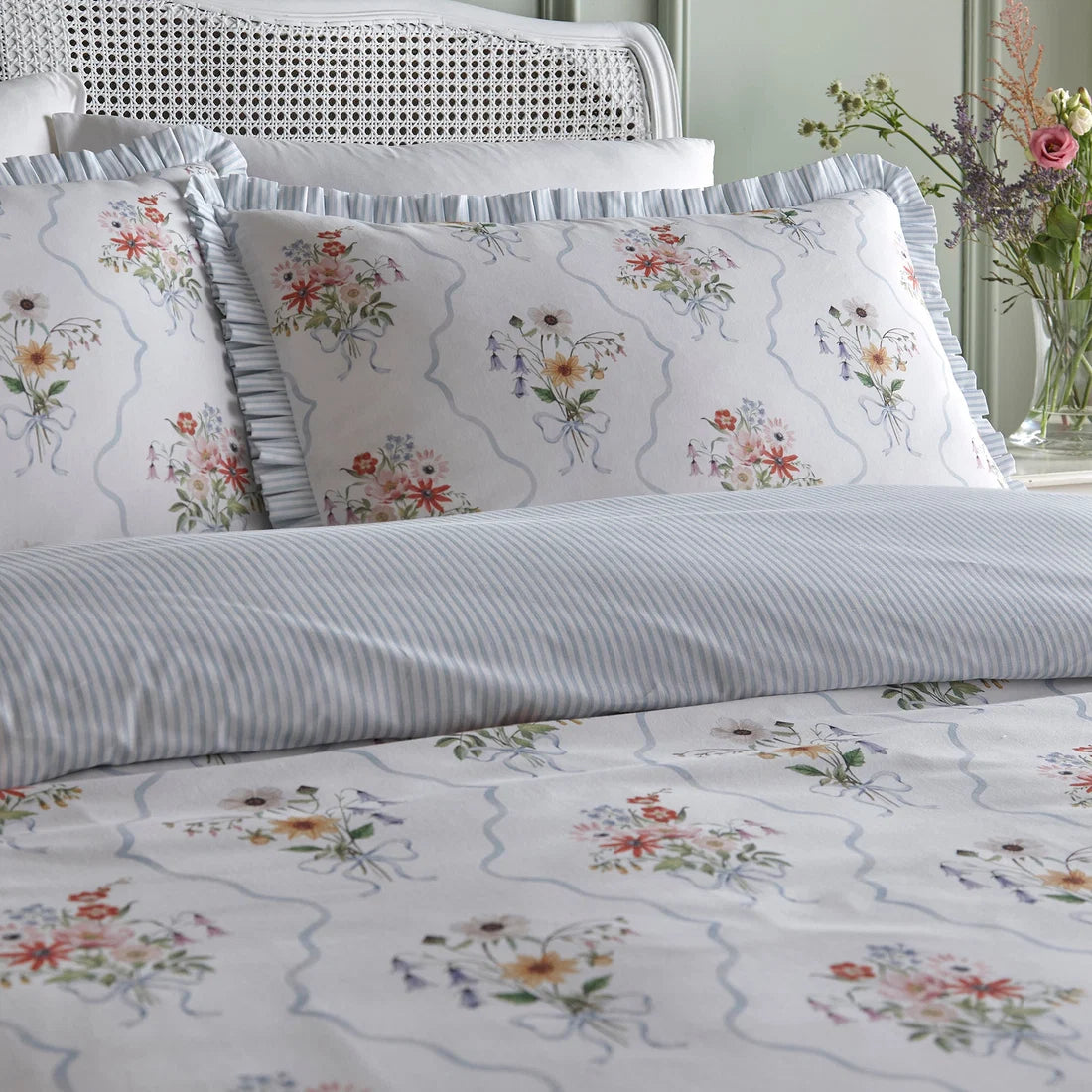 Close-up of the hand-painted floral bouquet and powder blue trellis design on the Appletree Floral Bouquet duvet cover set.