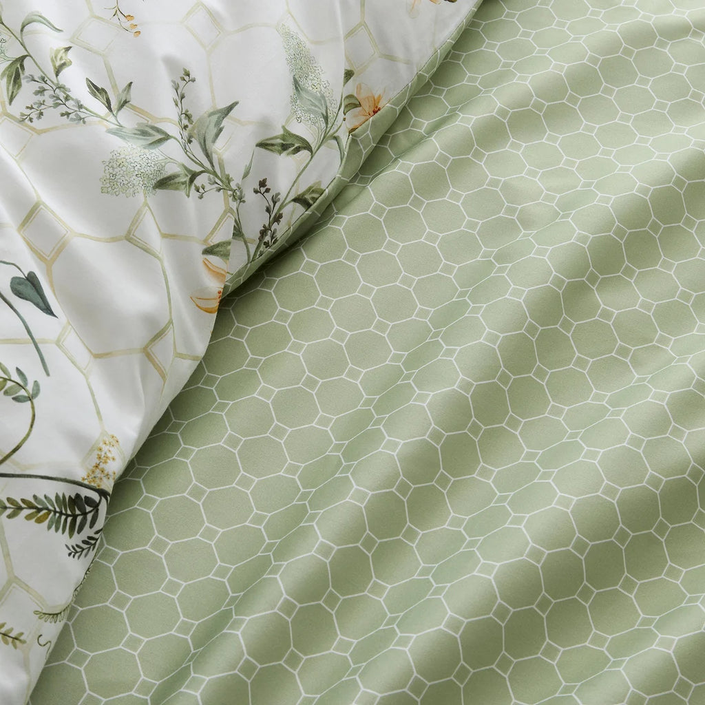 Close-up of the luxurious 200 thread count cotton sateen fabric and flat piped edging on the Appletree Floral Trellis duvet cover set.