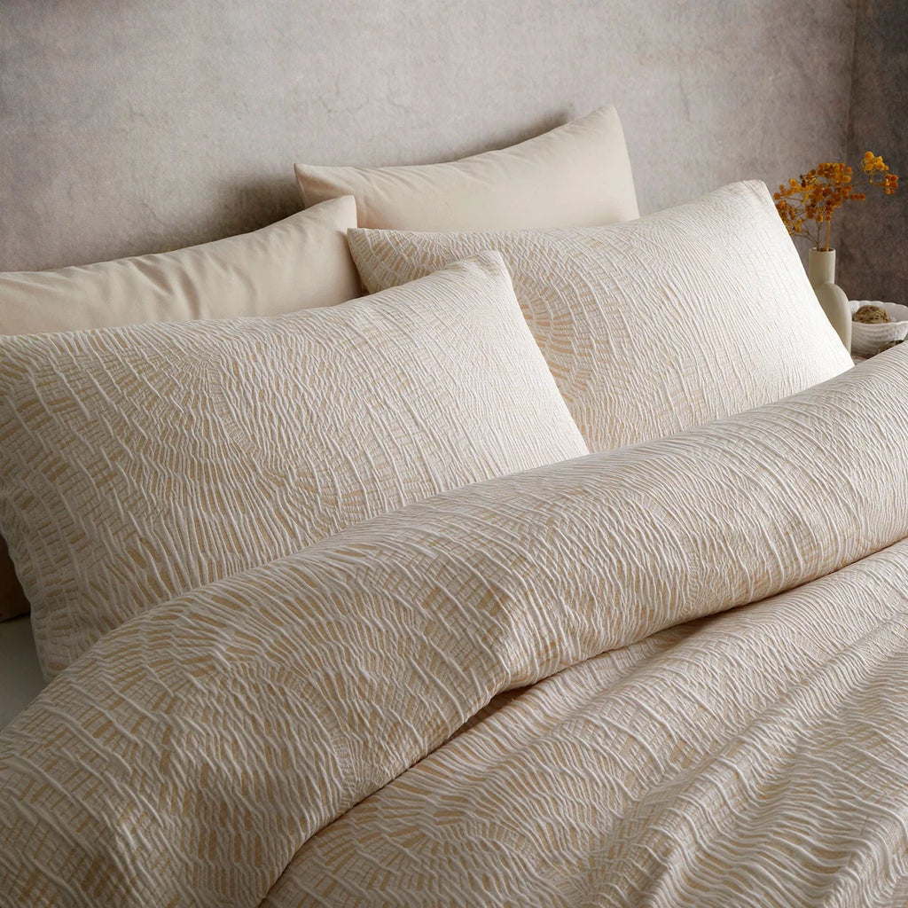 Close-up of the flowing abstract jacquard pattern on the Appletree Fossil Jacquard duvet cover set.