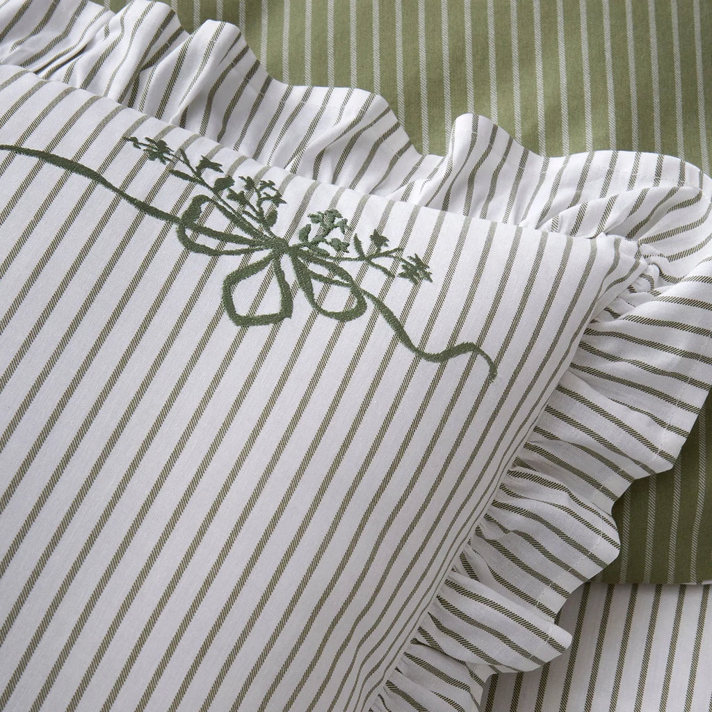 Close-up of the embroidered olive green bows on the Appletree Frilled Embroidered Bow Stripe pillowcases.