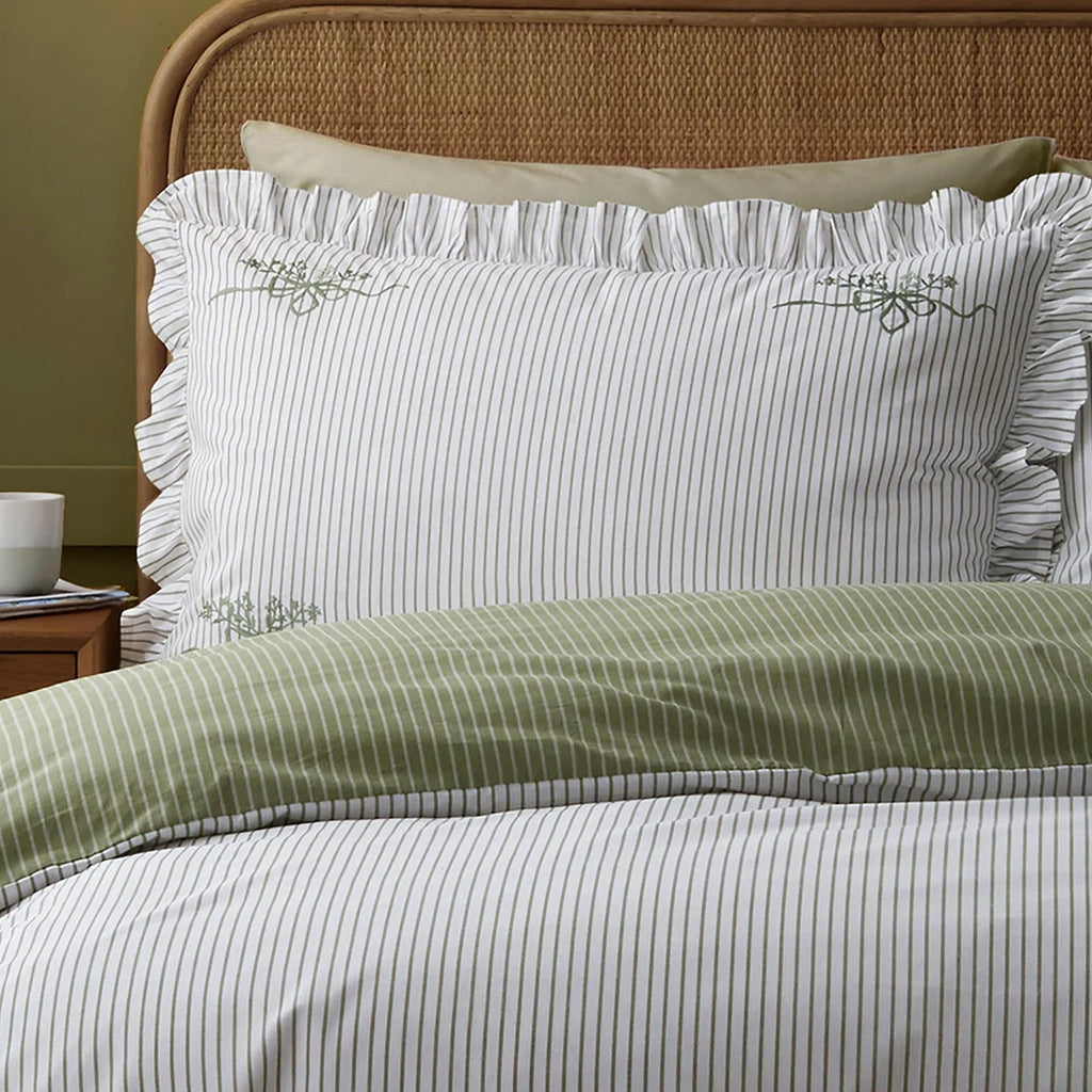 Close-up of the frilled edging and striped design on the Appletree Frilled Embroidered Bow Stripe duvet cover set.