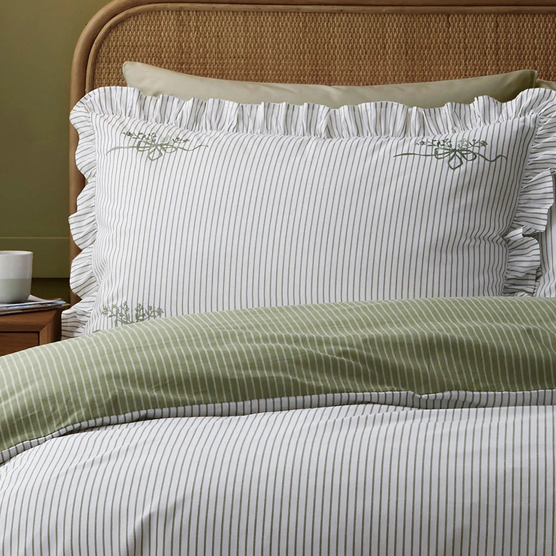 Close-up of the frilled edging and striped design on the Appletree Frilled Embroidered Bow Stripe duvet cover set.