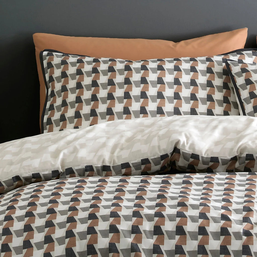 Close-up of the geometric pattern and black flat piped edging on the Appletree Jett duvet cover set.