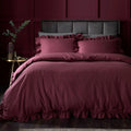 Appletree Loft Cassia Frill 100% cotton duvet cover set in berry with elegant frilled edging.