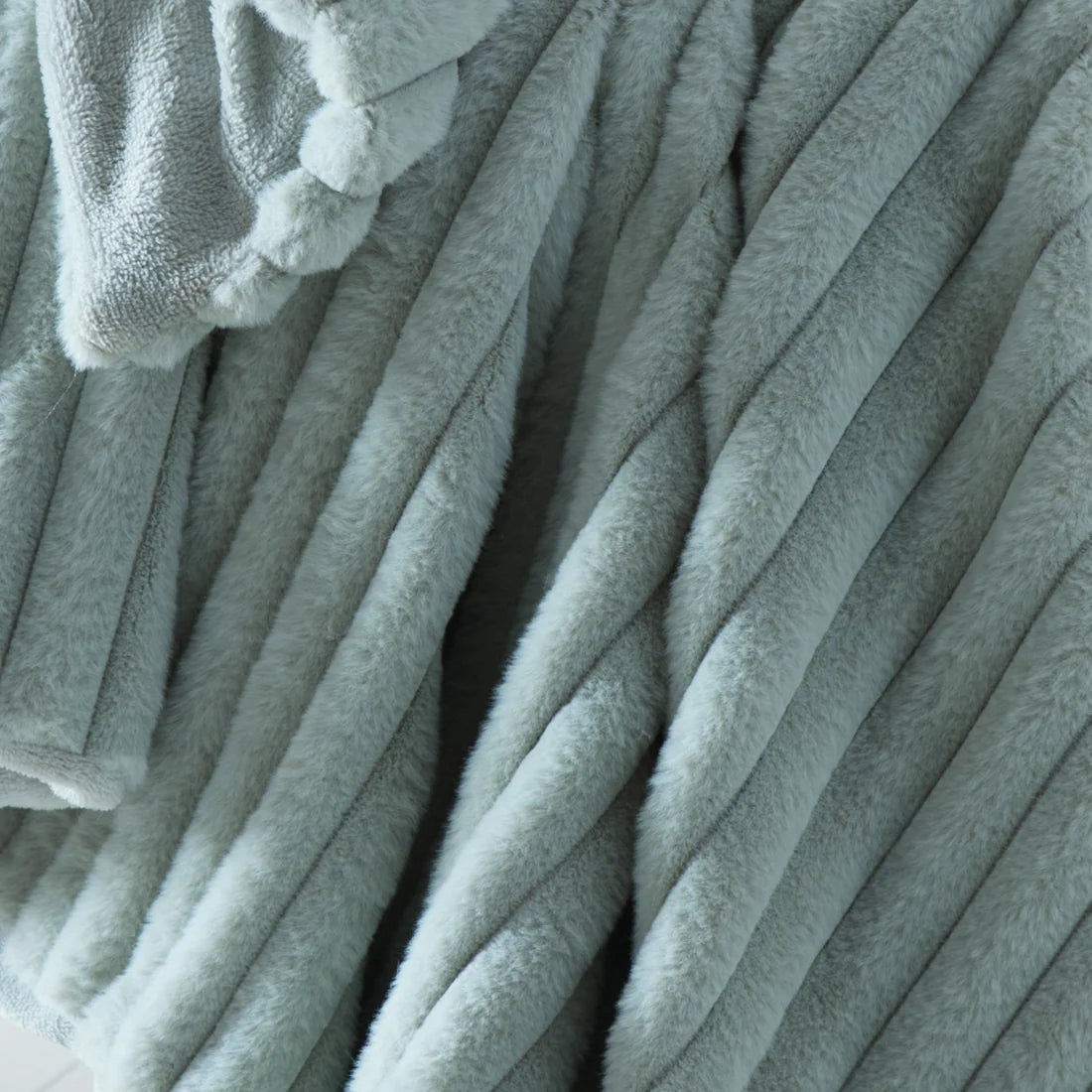 Close-up of the ribbed texture on the Appletree Morritz green throw.