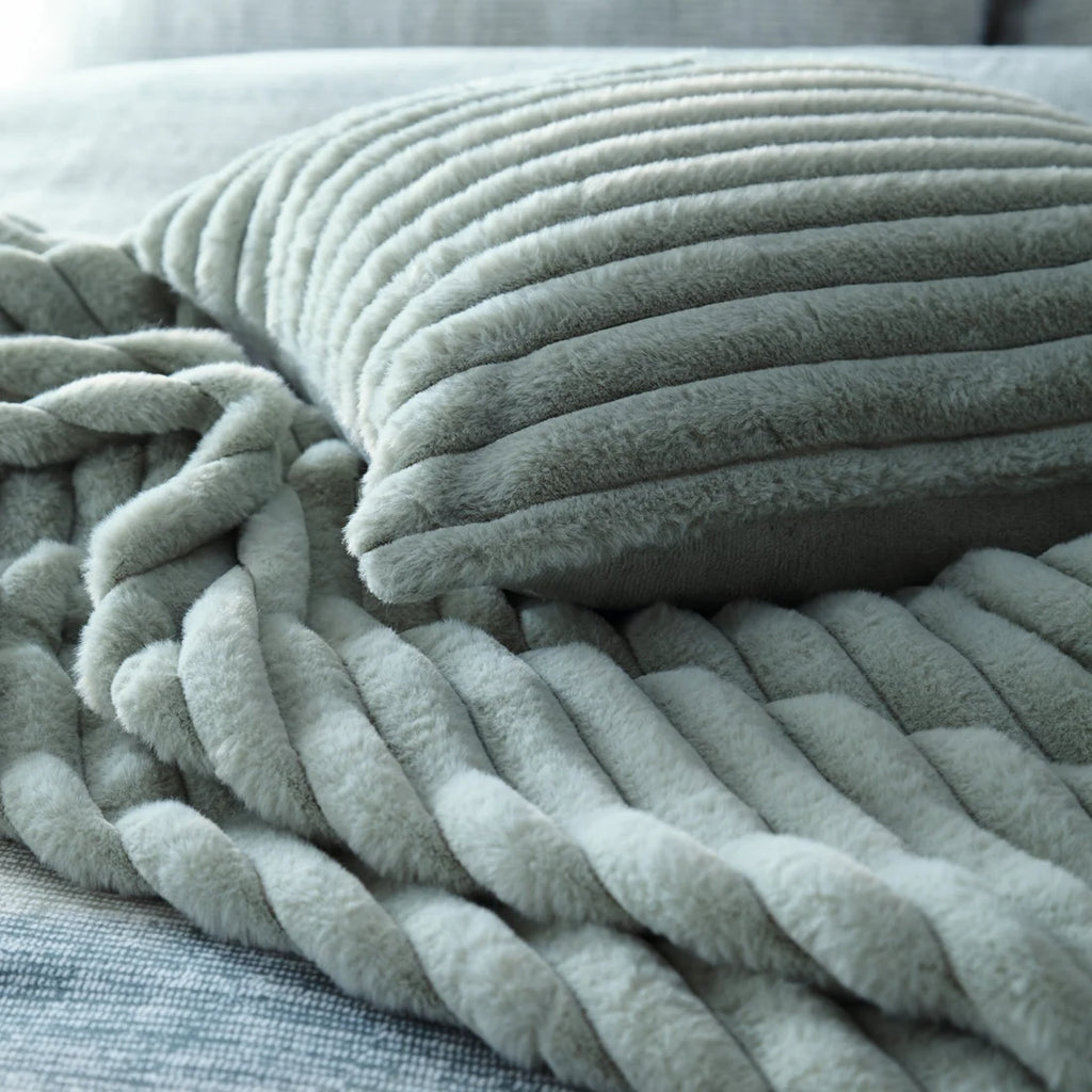 Close-up of the soft polyester fabric on the Appletree Morritz green throw.