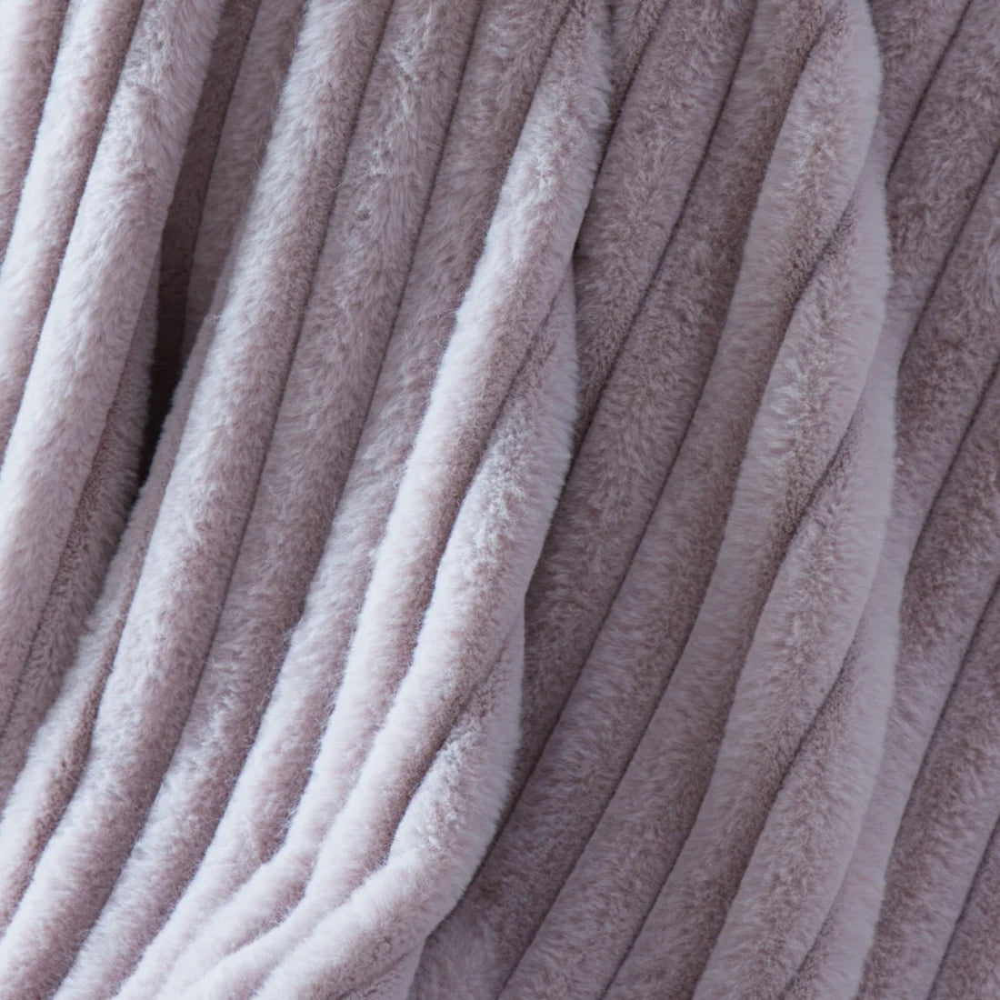 Close-up of the ribbed texture on the Appletree Morritz mauve throw.