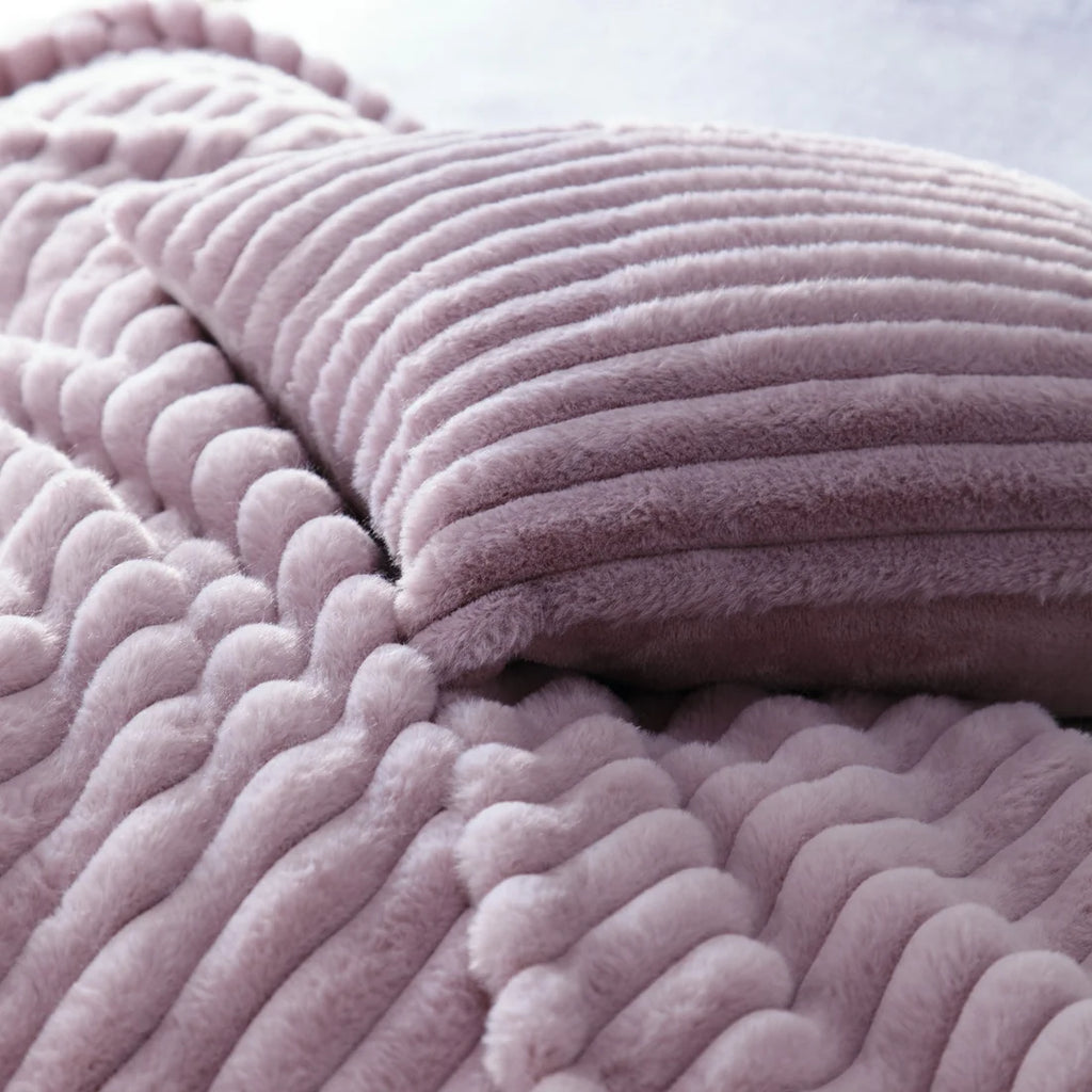 Close-up of the soft polyester fabric on the Appletree Morritz mauve throw.