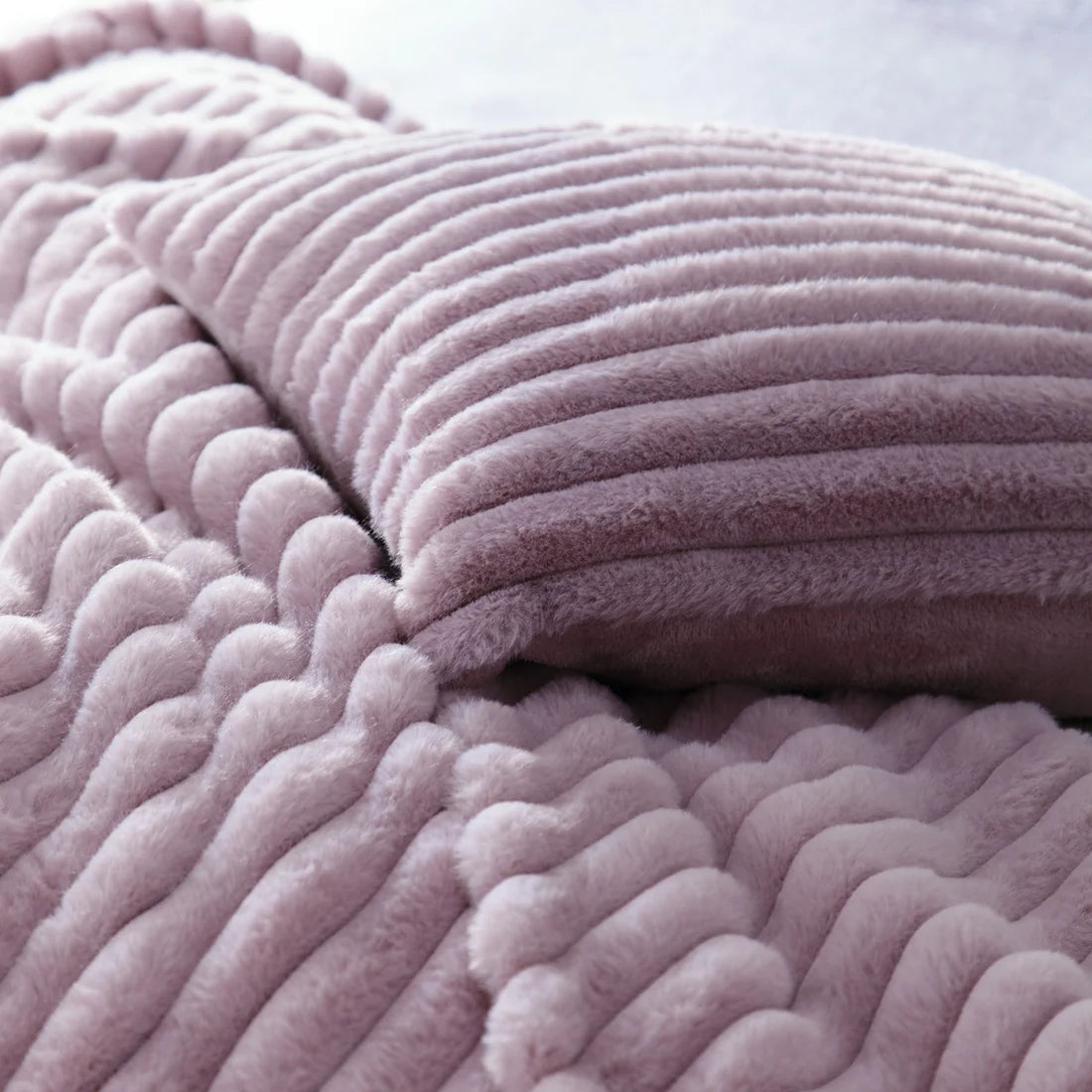 Close-up of the soft polyester fabric on the Appletree Morritz mauve throw.