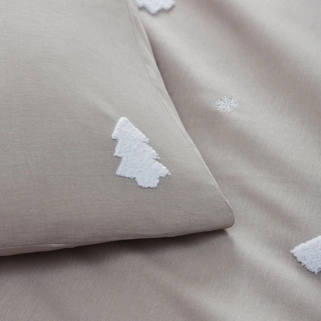 Close-up of the textured tufted Christmas trees on the Appletree Tufted Trees Natural bedding.