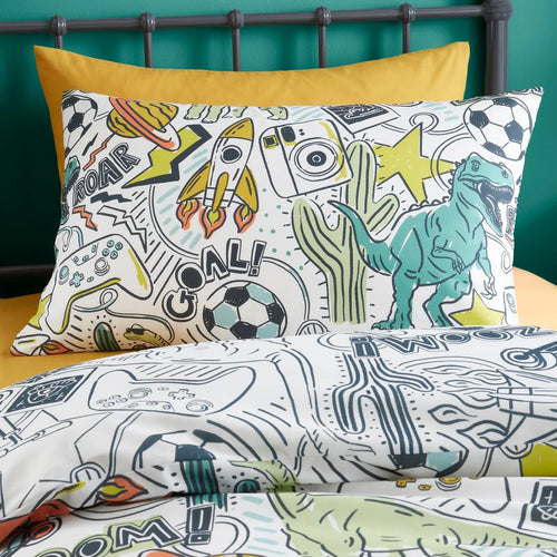 Children's bedding set with dinosaur and sports theme on a bed with yellow pillow.