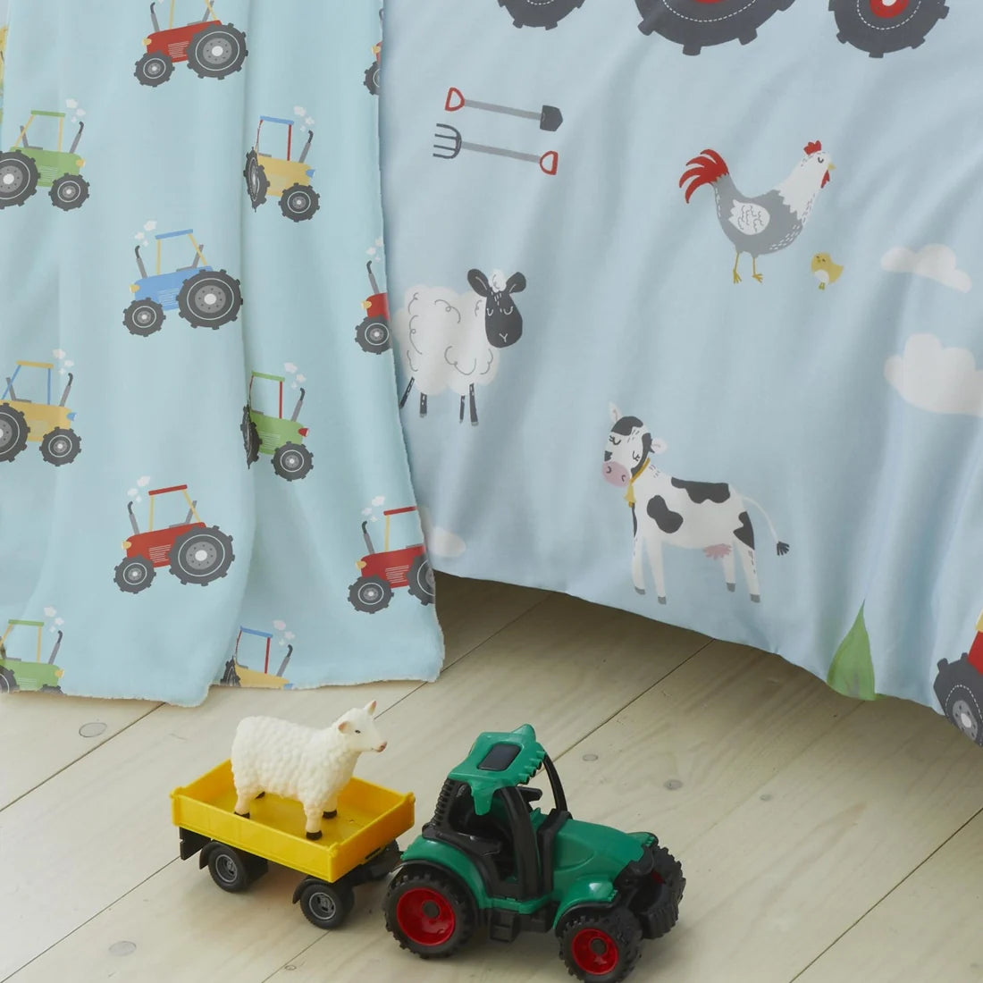 Bedlam Farmyard Friends reversible fleece throw in blue featuring colourful tractors.
