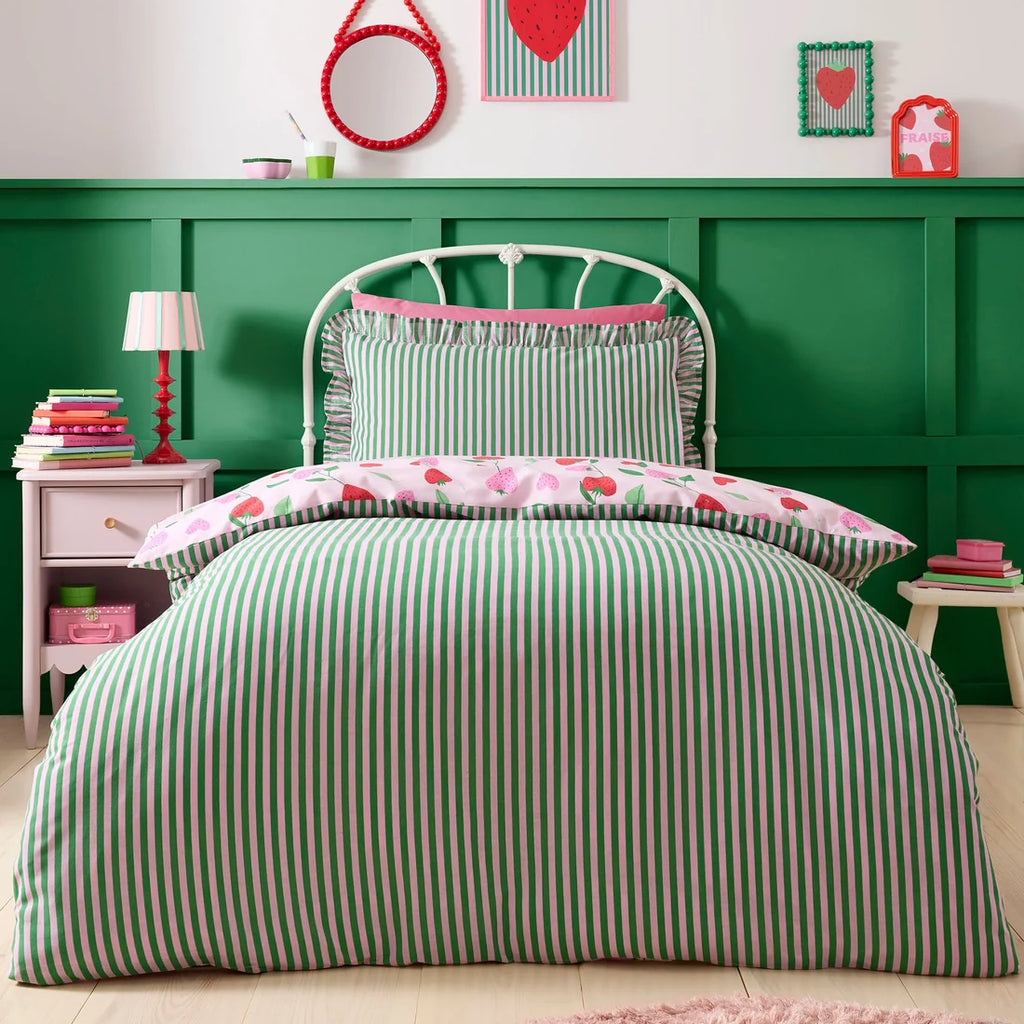 Bedroom with green and white striped bedding and decorative items on a green wall.