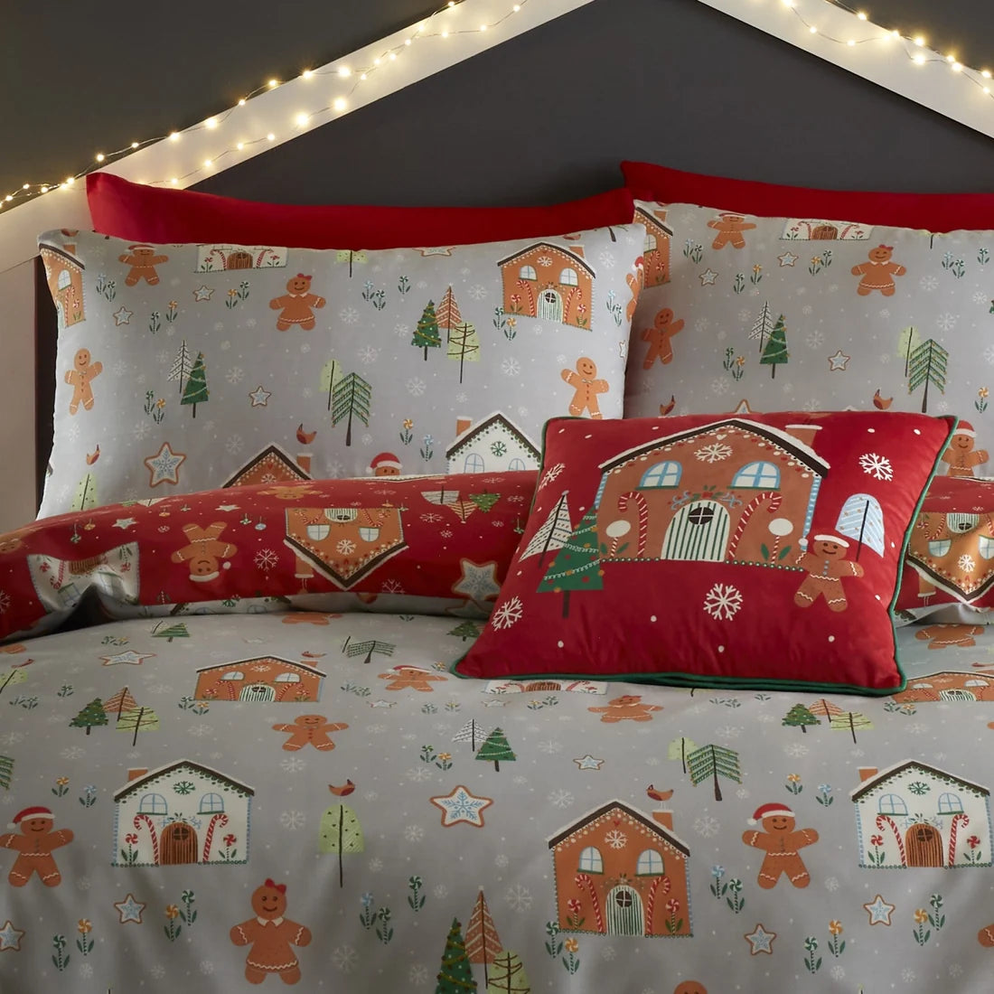 Christmas-themed bedding set with gingerbread houses and cookies on a gray background.