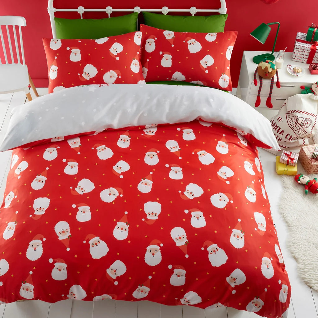 Reverse of duvet cover set adored with santa heads on a red background. 