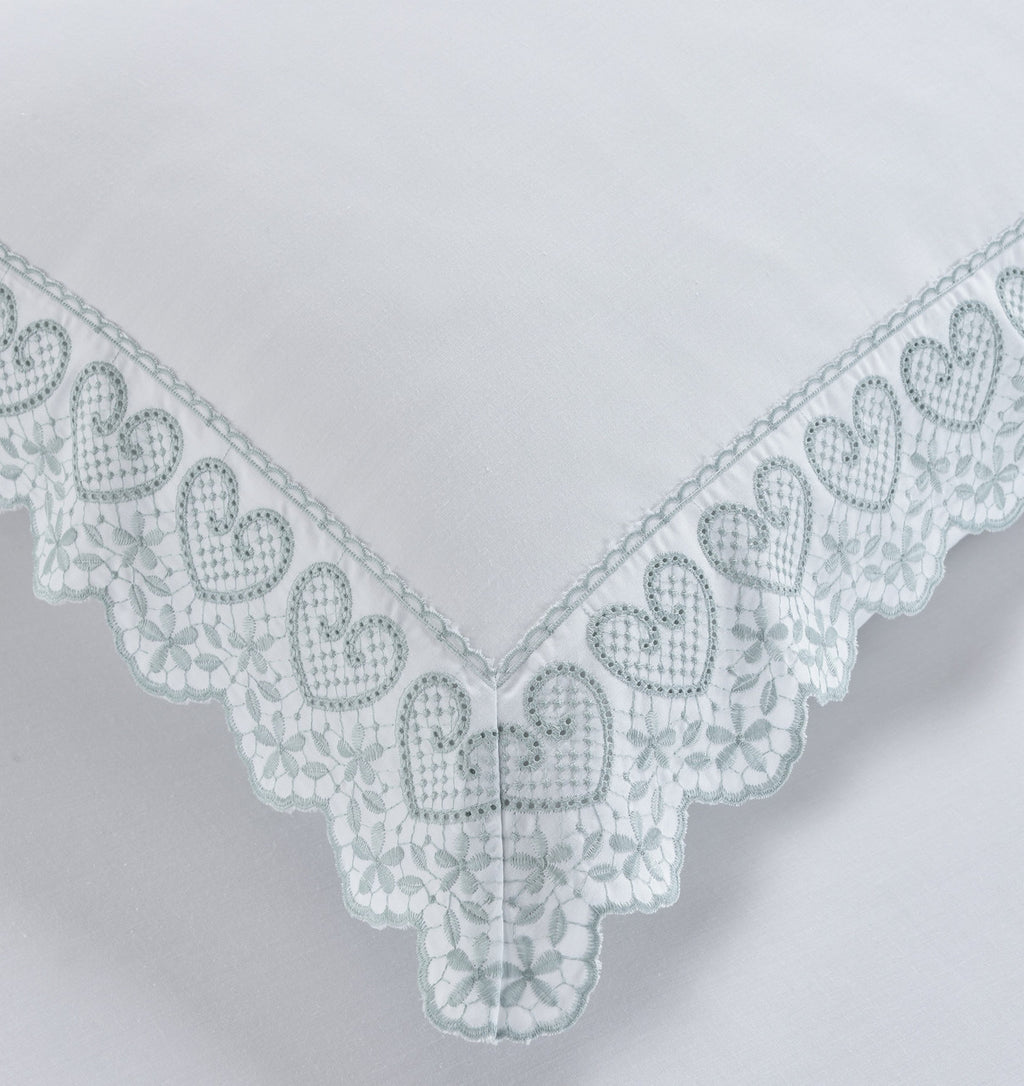 Close-up of the heart-shaped embroidery and lace trim on the Belle Maison Elise duvet cover set.
