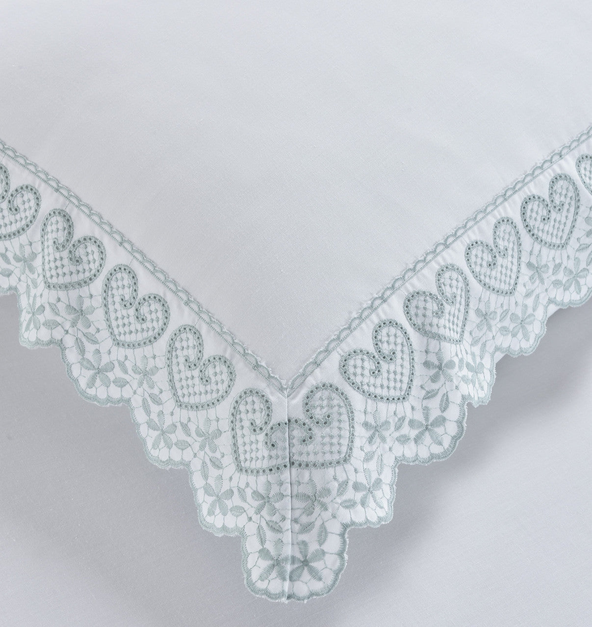 Close-up of the heart-shaped embroidery and lace trim on the Belle Maison Elise duvet cover set.