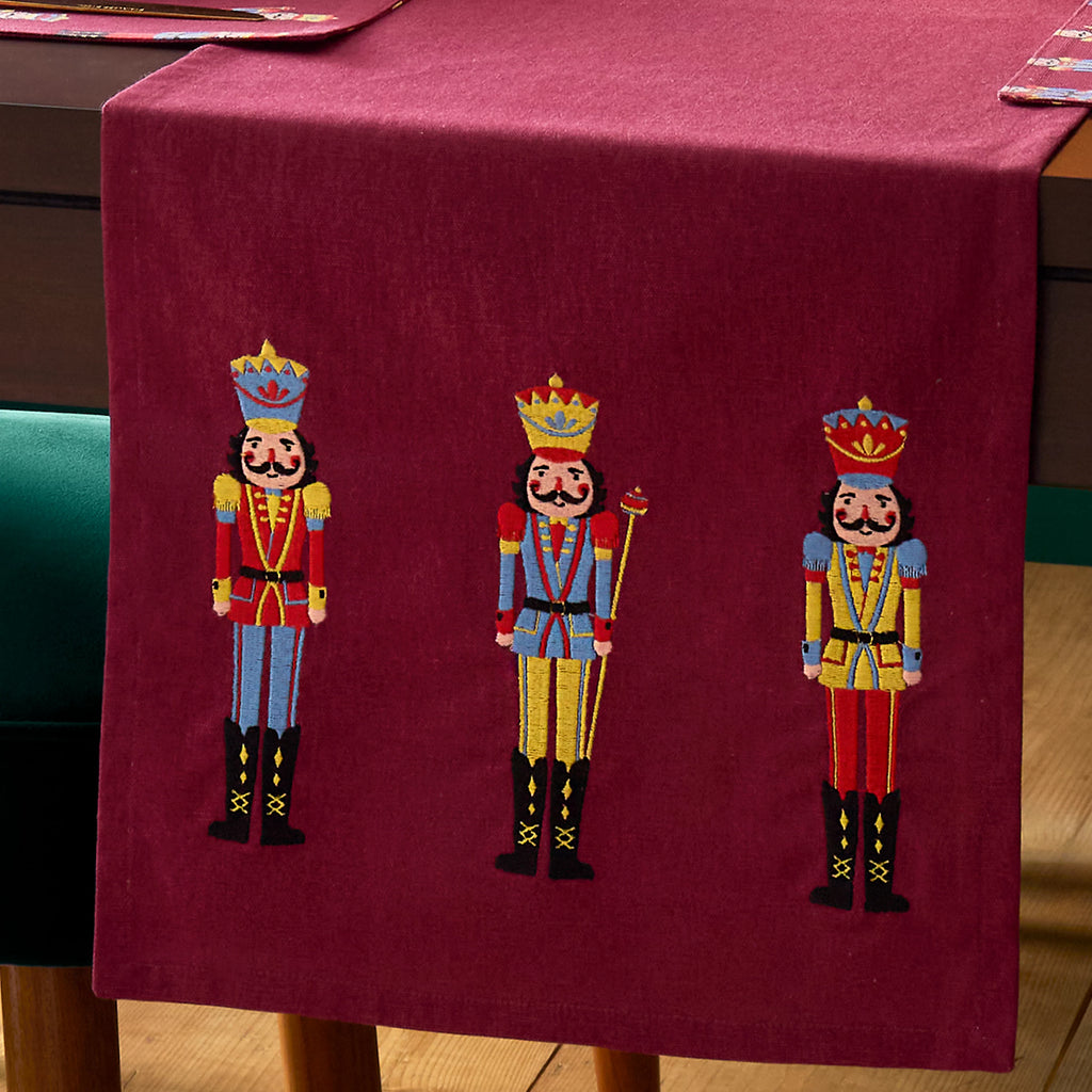 Catherine Lansfield Christmas Nutcracker Embroidered Cotton Table Runner in Plum