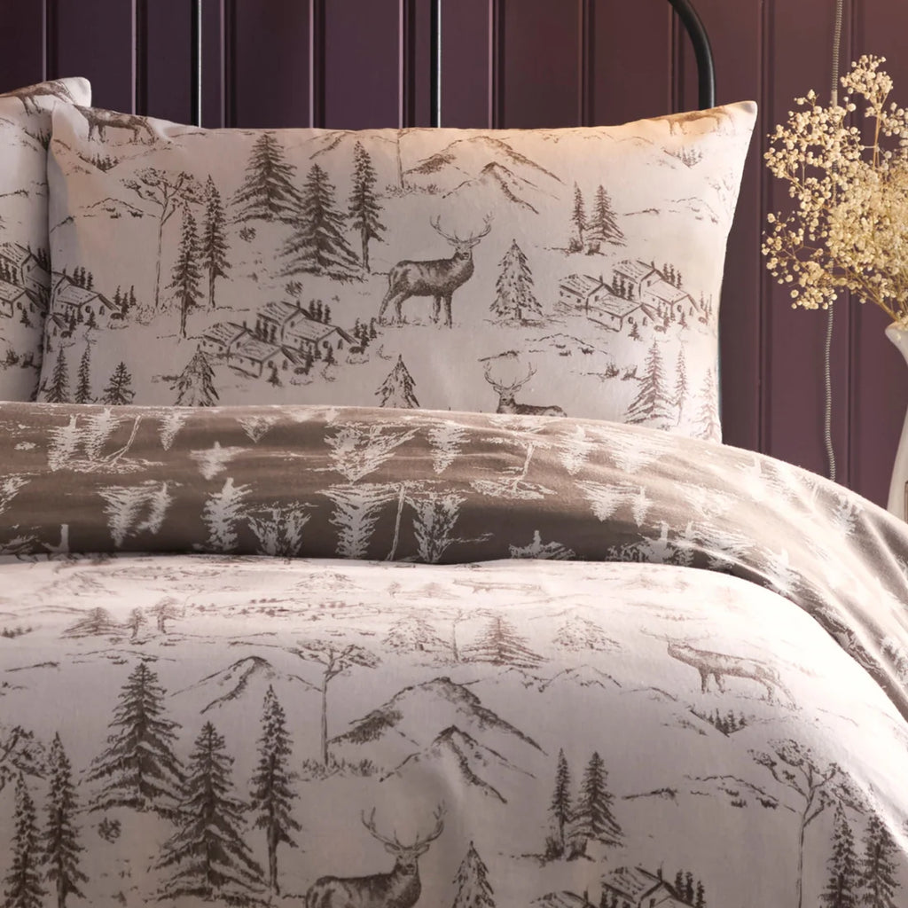 Close-up of the hand-drawn stag and Alpine lodge design on the Dreams & Drapes Alpine Stag duvet cover set.