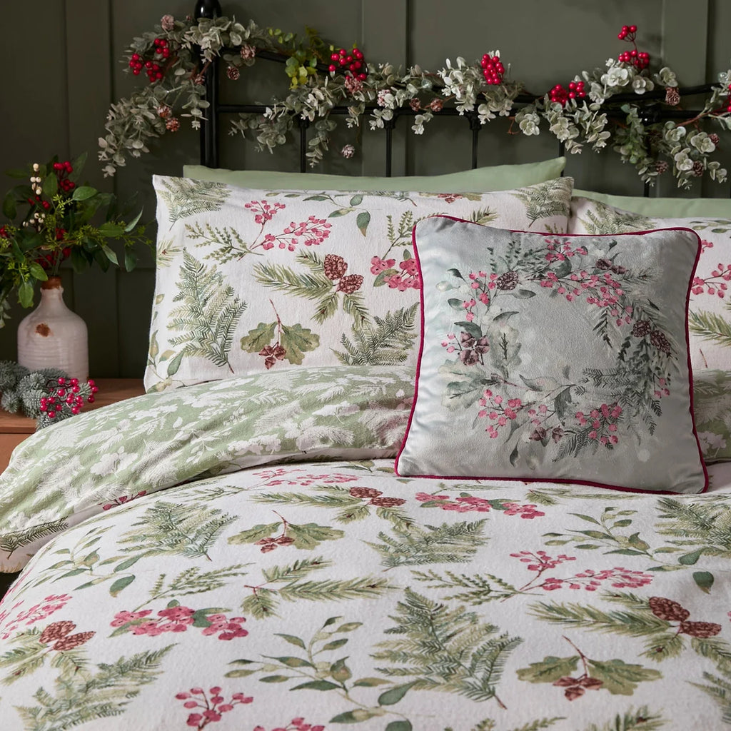 Close-up of the hand-painted evergreen sprigs, berries and fern design on the Dreams & Drapes Winter Sprigs duvet cover set.