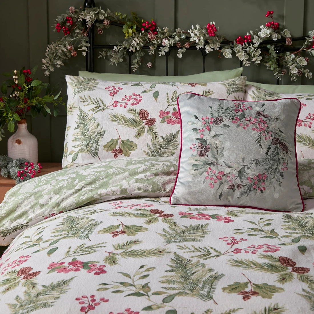 Close-up of the hand-painted evergreen sprigs, berries and fern design on the Dreams & Drapes Winter Sprigs duvet cover set.