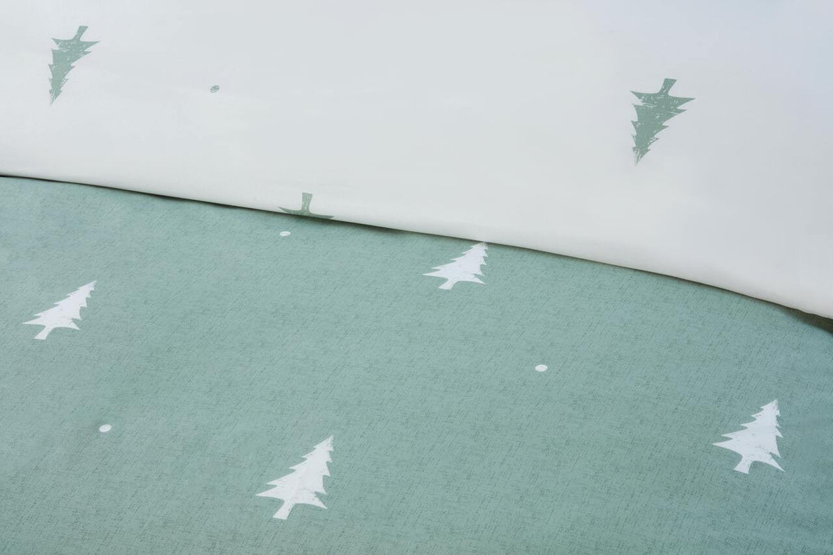 Close-up of the white fir trees and snow-like dots on the Sage Green duvet cover set.