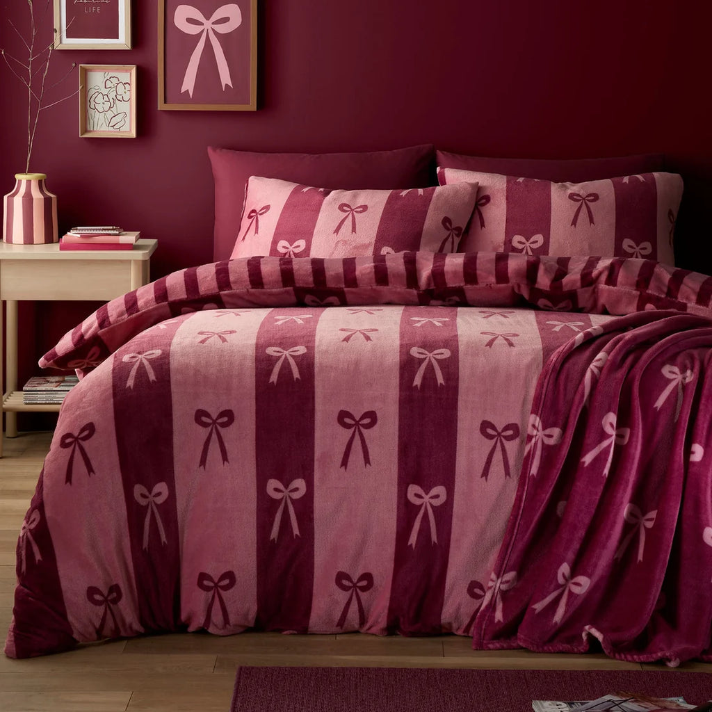 Fusion Bows berry duvet cover set styled in a contemporary bedroom.