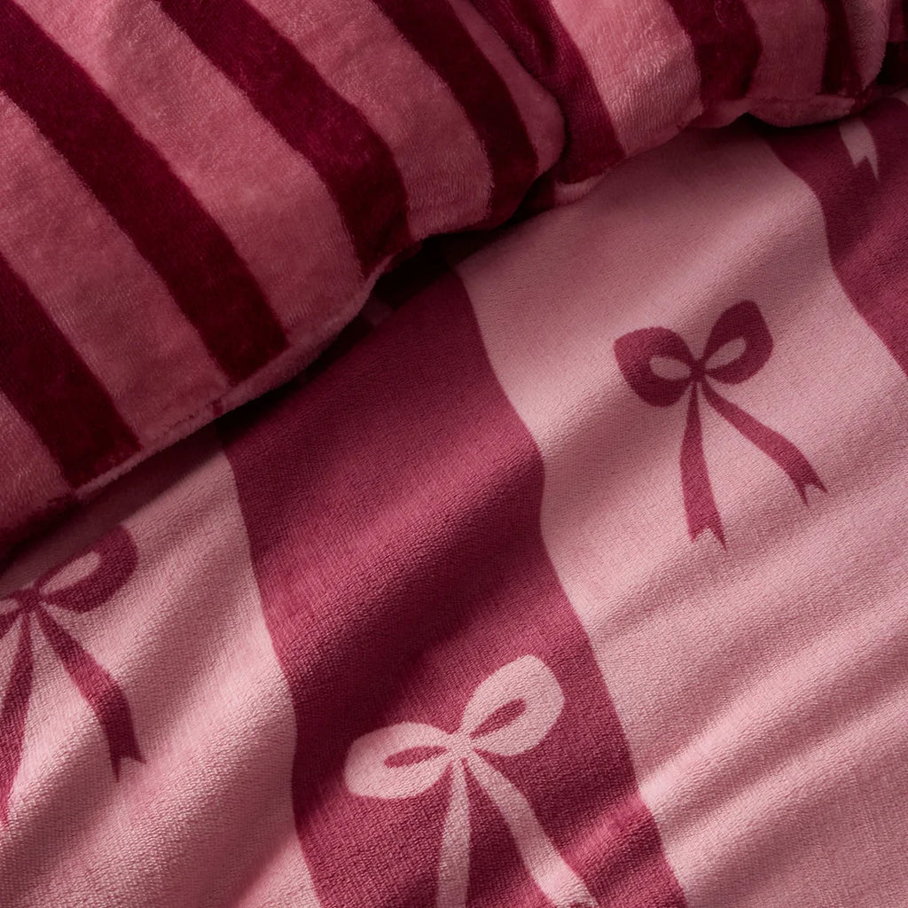 Close-up of the berry and blush bow pattern on the Fusion Bows duvet cover set.