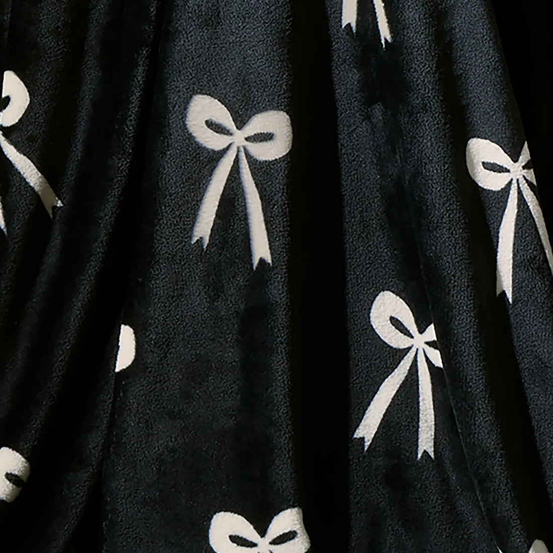 Close-up of the soft fleece fabric on the Fusion Bows monochrome throw.