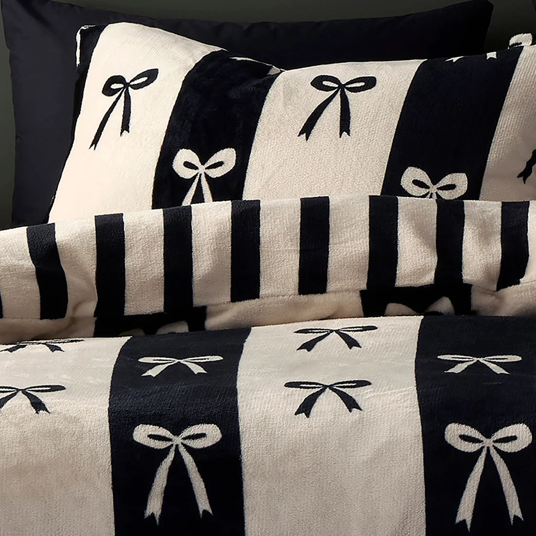 Close-up of the ribbon bow and striped design on the Fusion Bows duvet cover set.