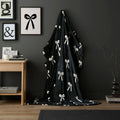 Fusion Bows fleece throw in monochrome with a stylish ribbon bow design.
