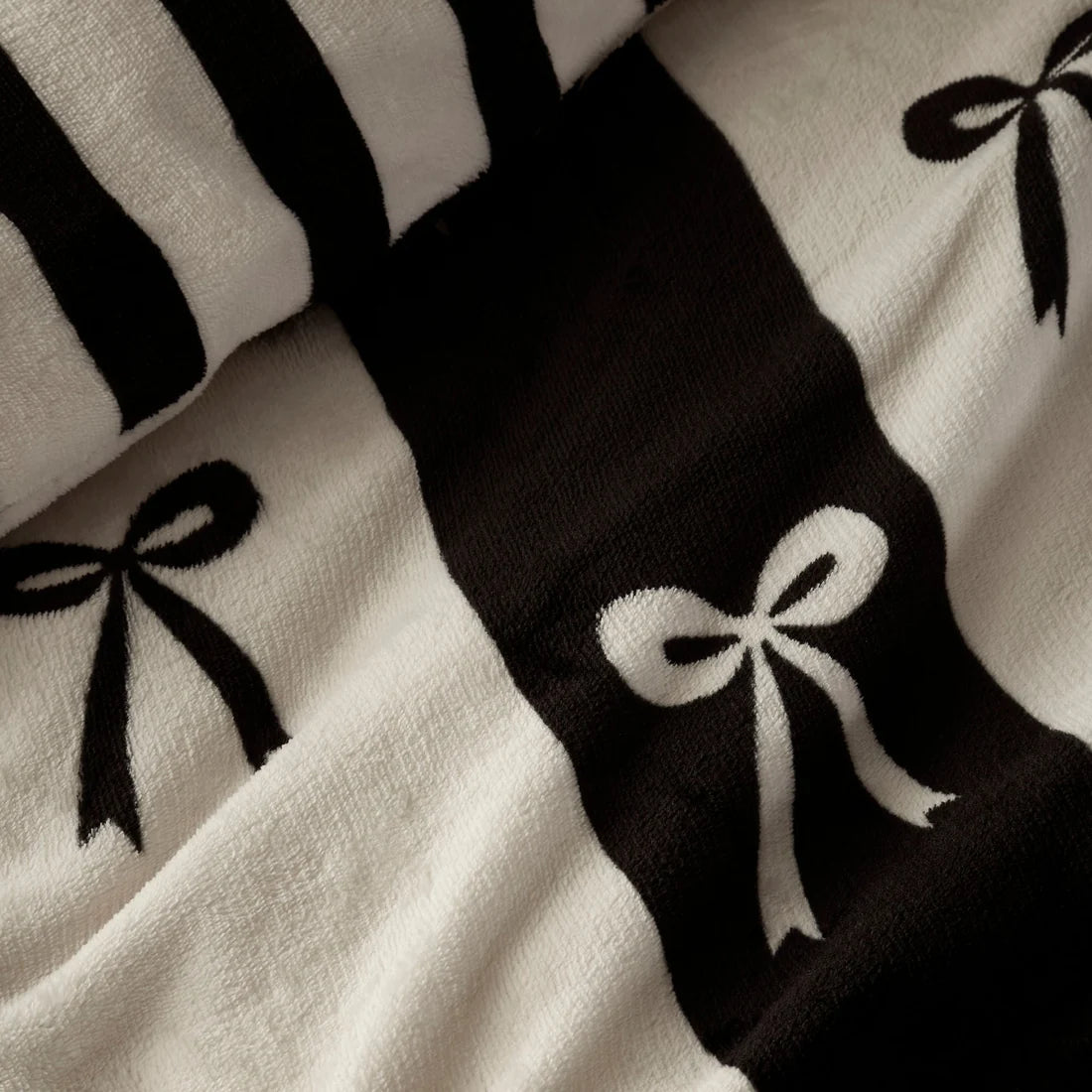 Close-up of the monochrome bow pattern on the Fusion Bows duvet cover set.