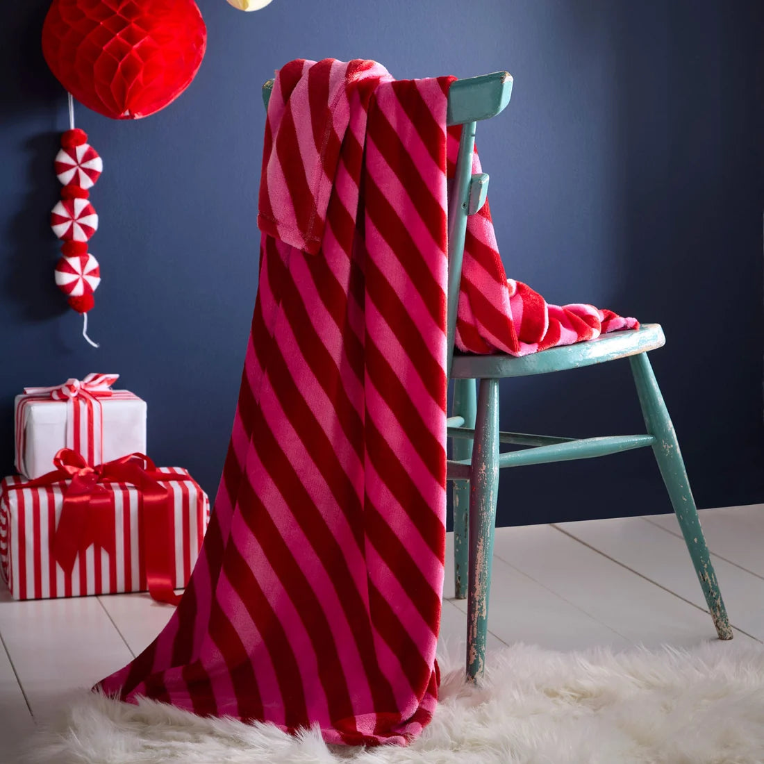Fusion Candy Stripe Christmas fleece throw in pink measuring 120 x 150cm.