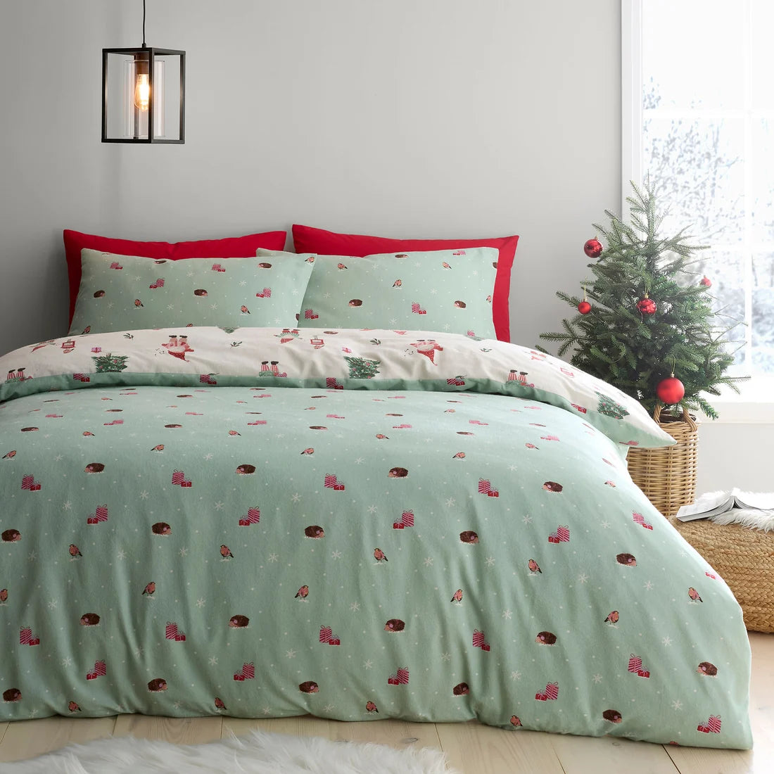 Snowy woodland reverse featuring gifts, hedgehogs and birds on the Fusion Christmas Gonks duvet cover set.