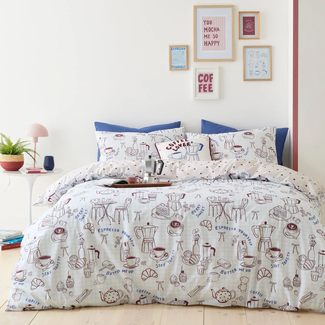 Fusion Coffee Club blue duvet cover set styled in a contemporary bedroom.