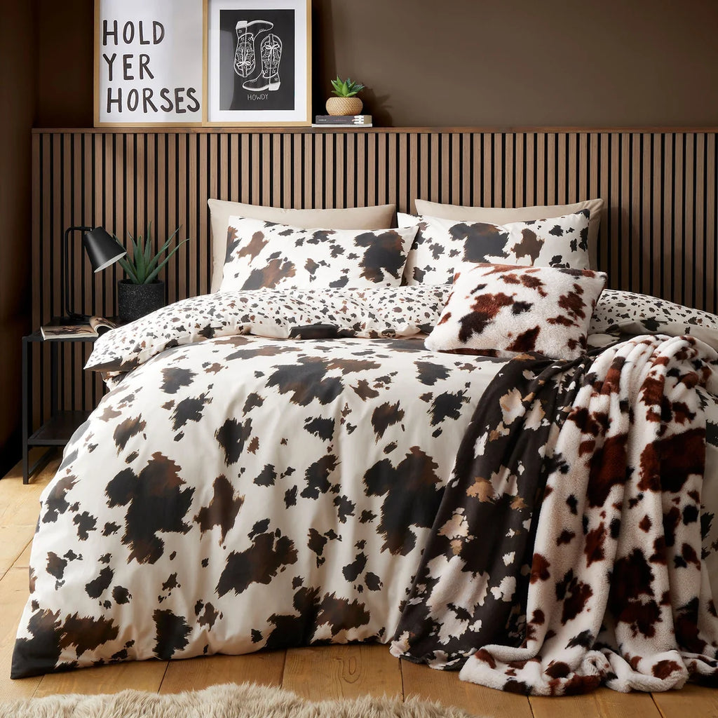 Fusion Cow Print natural duvet cover set styled in a contemporary bedroom.