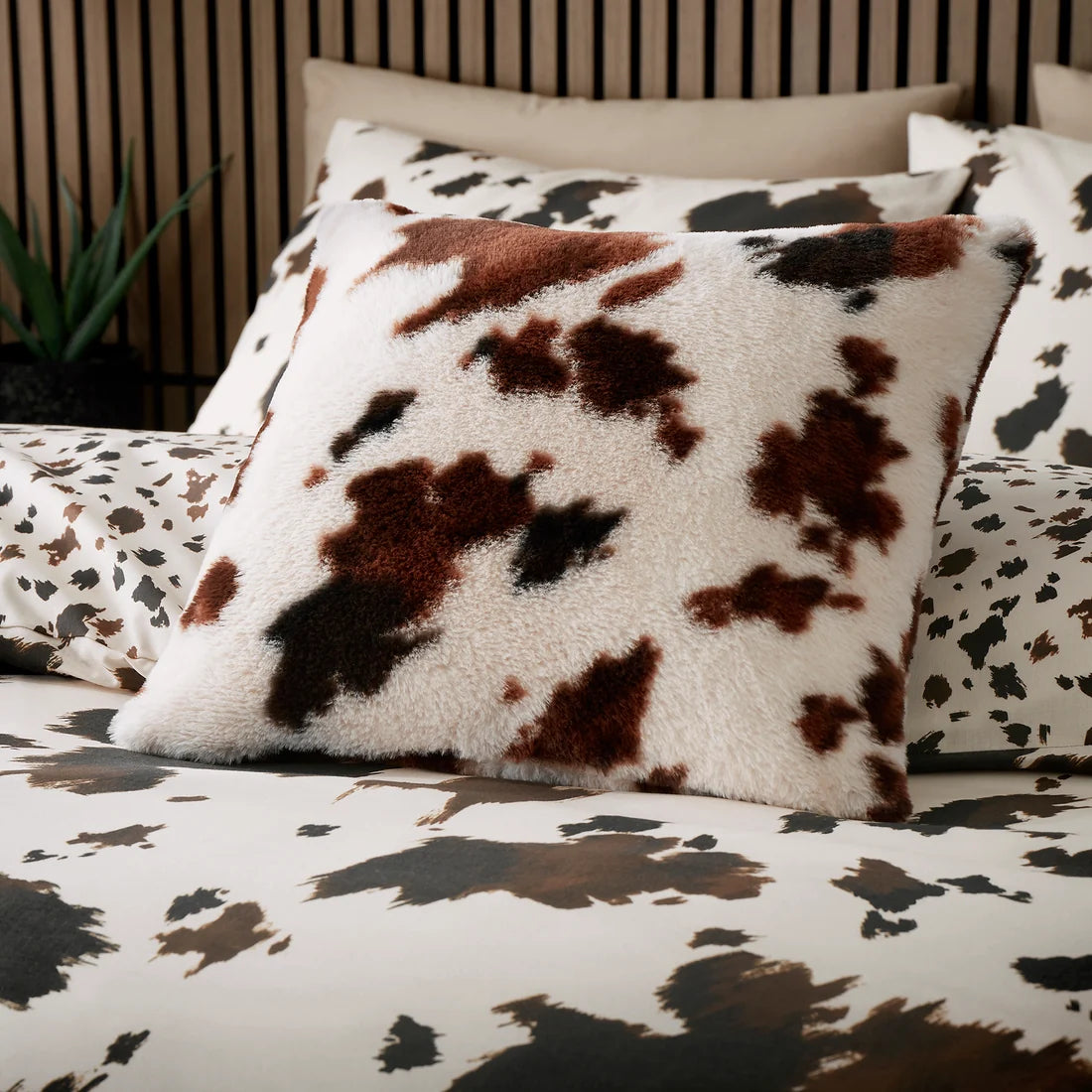 Fusion Cow Print Faux Fur cushion in Natural 43 x 43cm with a bold cowhide-inspired design.