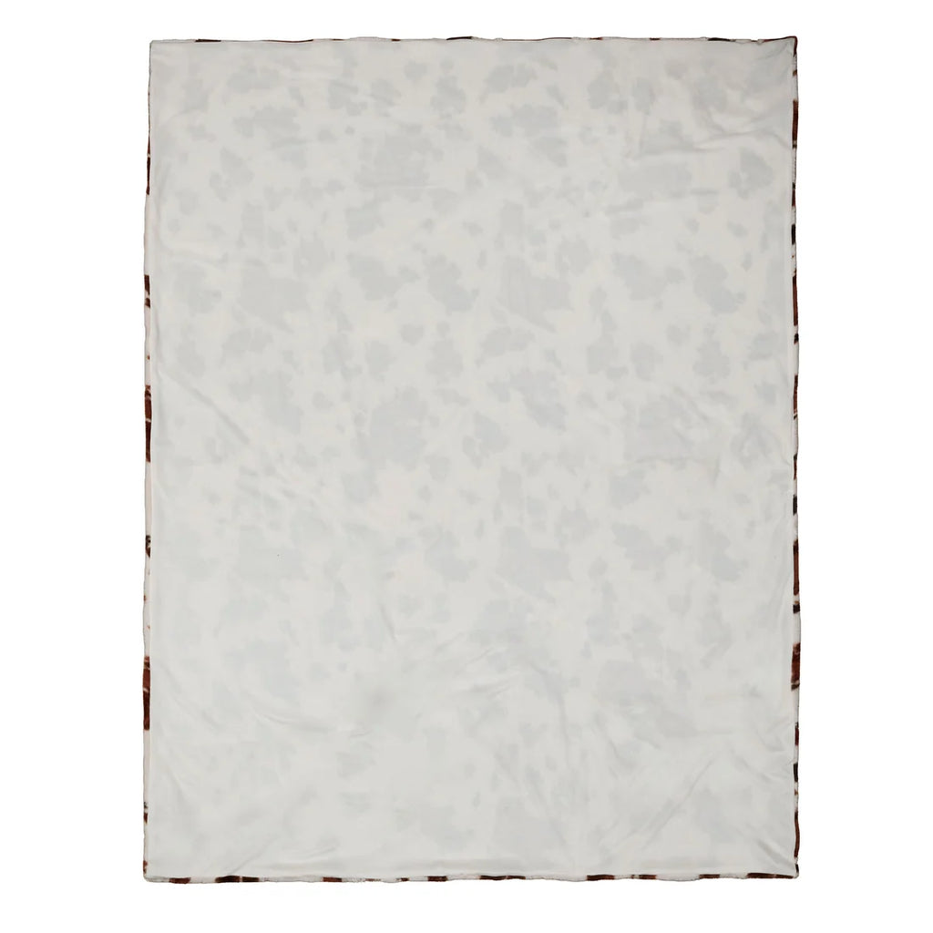 Detailed view of the Fusion Cow Print Faux Fur bedspread showing its soft textured finish.