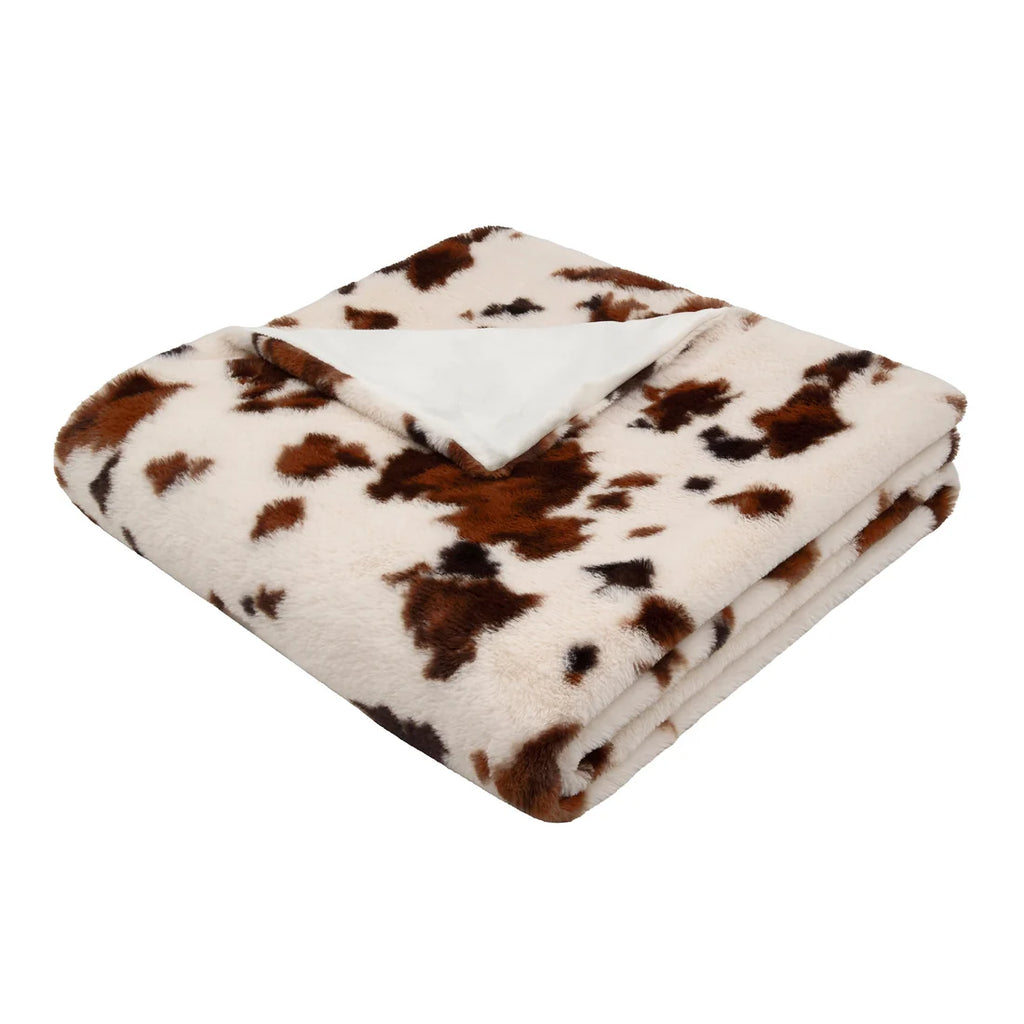 Close-up of the plush faux fur texture on the Fusion Cow Print bedspread in Natural.