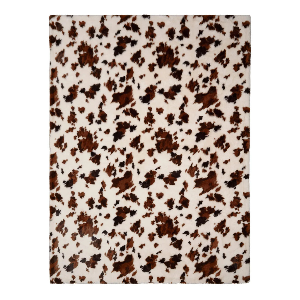 Close-up of the cowhide-inspired pattern on the Fusion Cow Print Faux Fur bedspread.