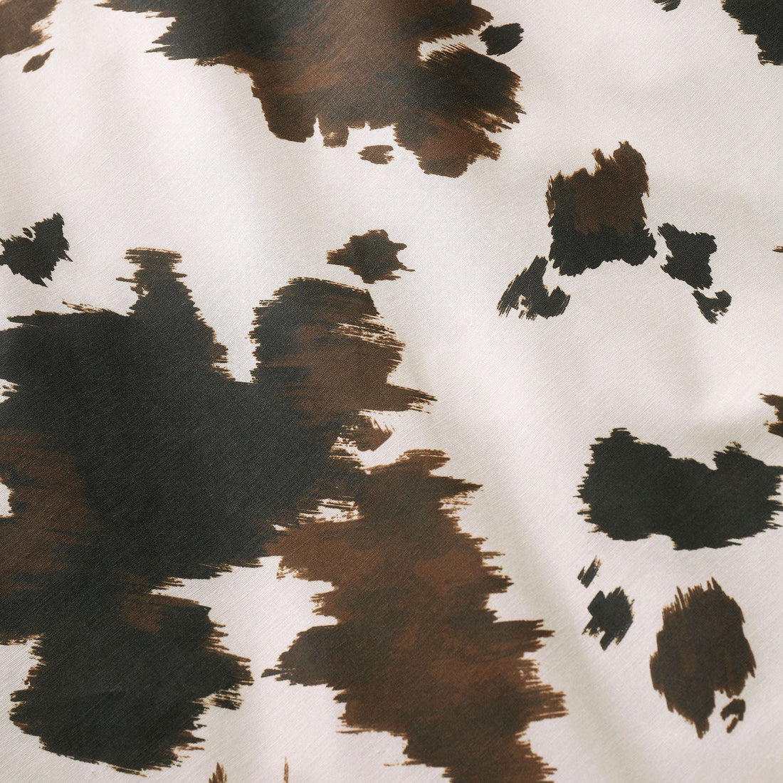 Close-up of the soft cotton-rich polycotton fabric on the Fusion Cow Print duvet cover set.