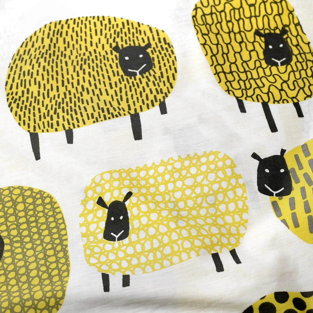 Close-up of the soft cotton-rich polycotton fabric on the Fusion Dotty Sheep duvet cover set.