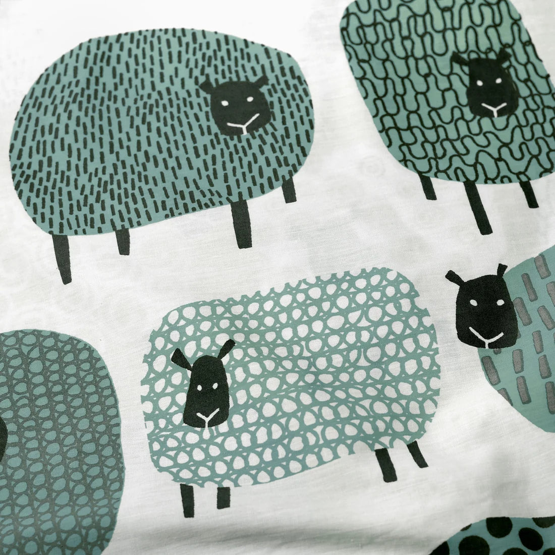 Close-up of the soft cotton-rich polycotton fabric on the Fusion Dotty Sheep duvet cover set.