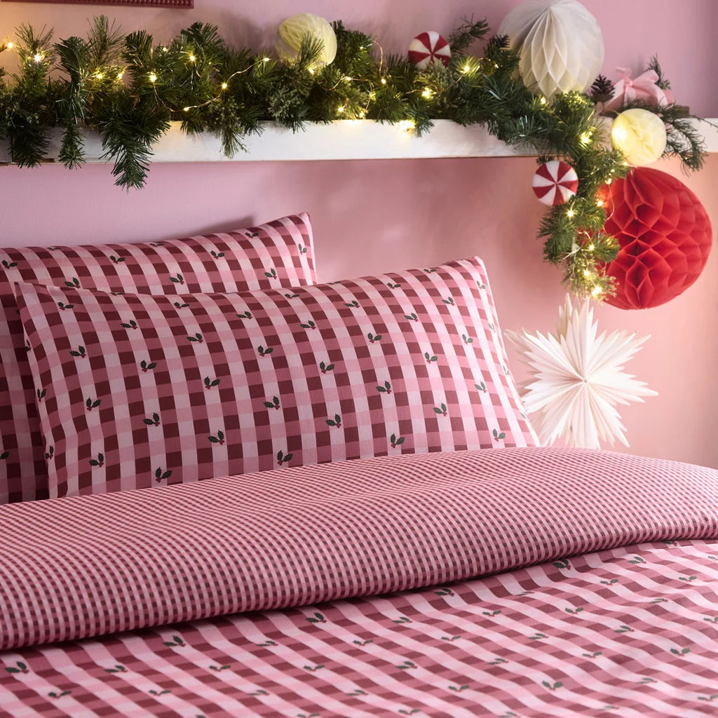 Close-up of the gingham check and holly sprig pattern on the Fusion Holly Gingham Christmas bedding.