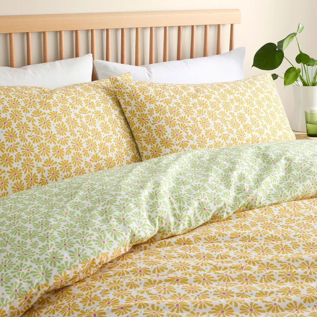Close-up of the sunshine yellow daisy print on the Fusion Retro Daisy Floral duvet cover set.