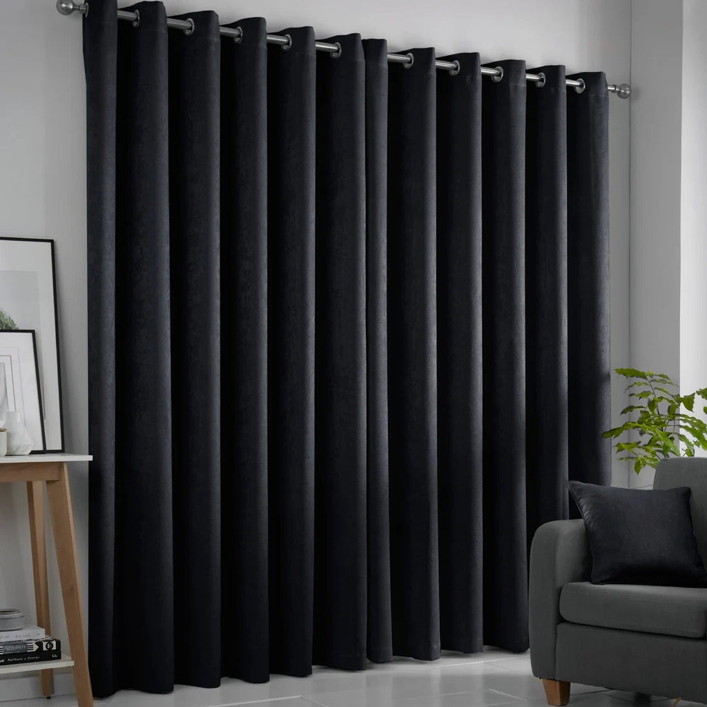 Fusion Strata black eyelet curtains styled in a contemporary living room.